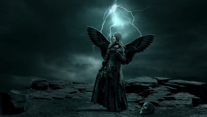 Dark angel with black wings under lightning