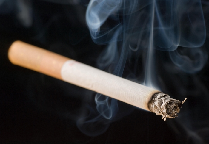 Burning cigarette with smoke