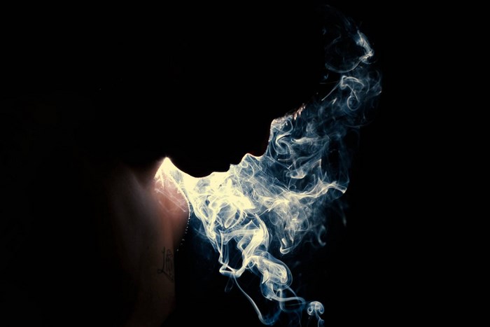 Person exhaling smoke