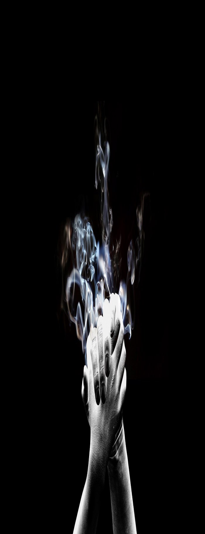 Smoke rising from clasped hands