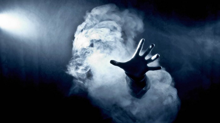 Hand reaching out of smoke