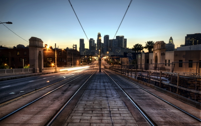 Los Angeles cityscape with tram tracks at dusk