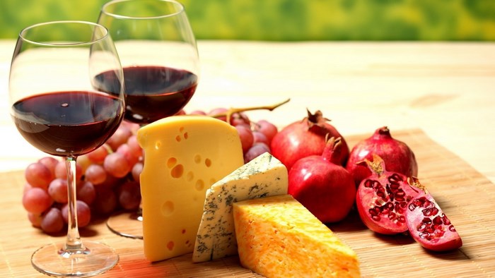 Wine, Cheese, Grapes, and Pomegranates on a Table