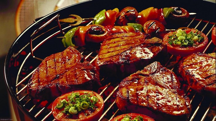 Steak and vegetable skewers on a grill
