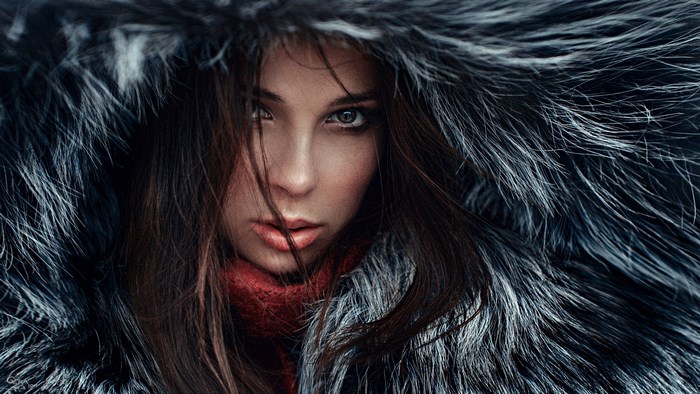 Woman in fur hood and red scarf
