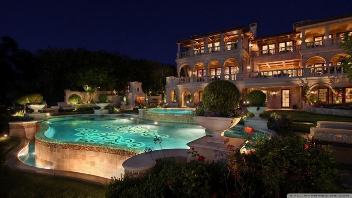 Luxury mansion with swimming pool at night