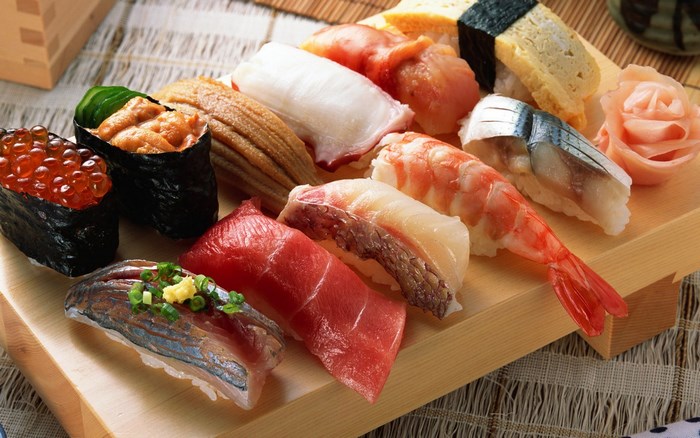 Assortment of sushi on a wooden platter