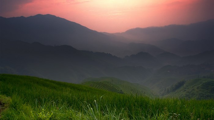 Mountain landscape with rice terraces at sunset