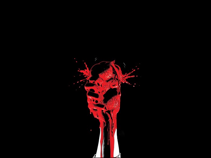 Hand crushing a heart with blood splatter
