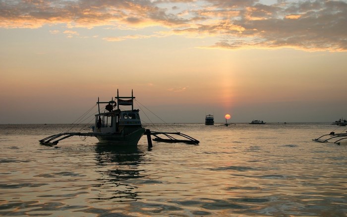 Boat on the water at sunset