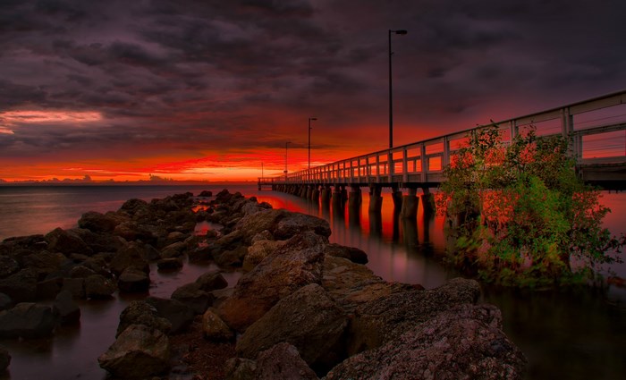 Pier over the ocean at sunset