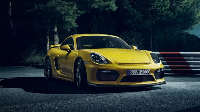 Yellow Porsche Cayman GT4 on a Race Track