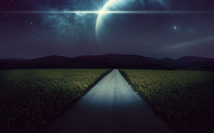 Road through field under alien planet sky