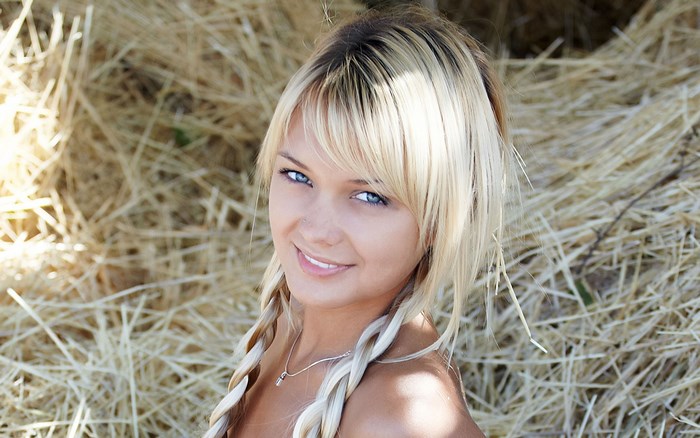 Blonde Woman with Braids Smiling Outdoors