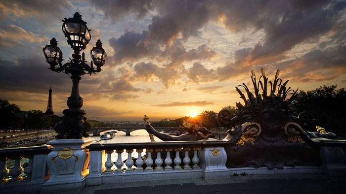 Paris bridge lamp and Eiffel Tower at sunset