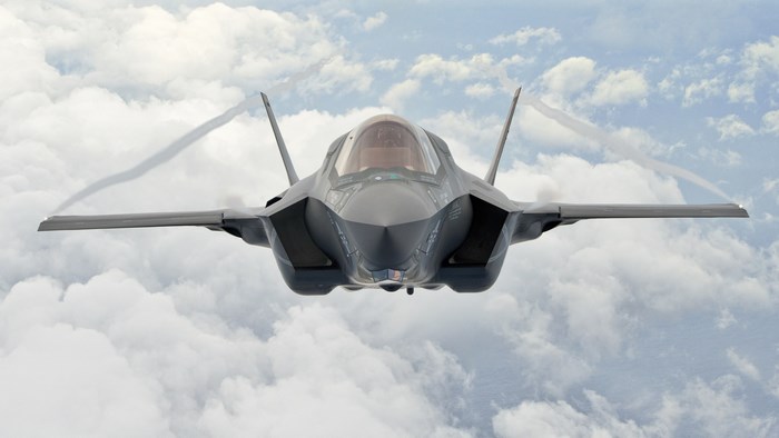 Lockheed Martin F-35 Lightning II jet flying through clouds