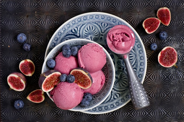 Scoops of berry ice cream with figs and blueberries