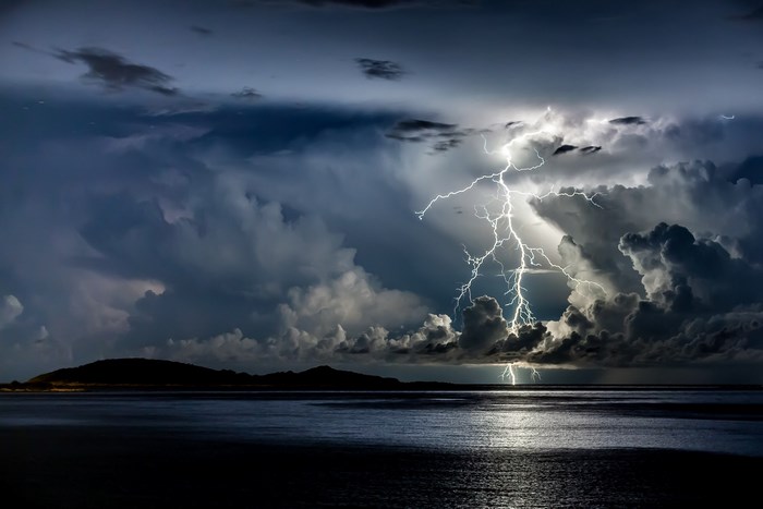 Lightning strike over the ocean during a storm