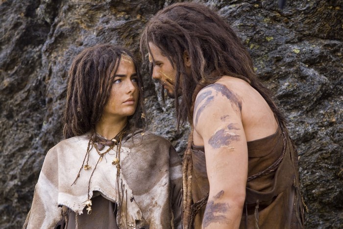Two people from 10,000 BC in front of a rock face