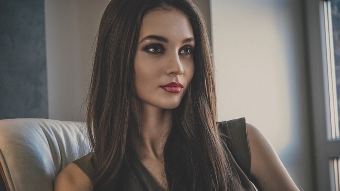 Portrait of Thoughtful Young Woman Indoors