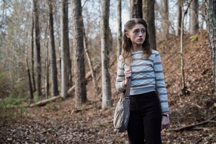 Nancy Wheeler from Stranger Things in a forest