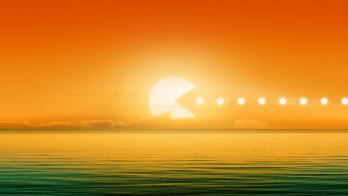 Pac-Man eating suns at sunset over the ocean
