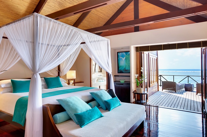 Maldives water villa bedroom with ocean view