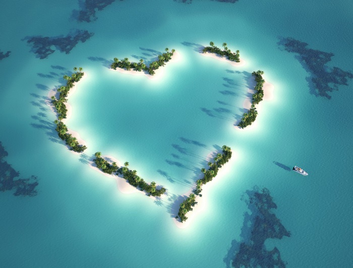 Heart-shaped island with palm trees and a boat