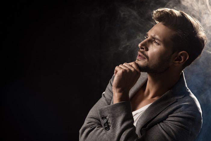 Man in gray jacket with smoke