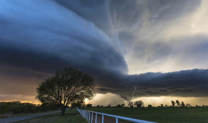 Tornado storm with lightning over a field