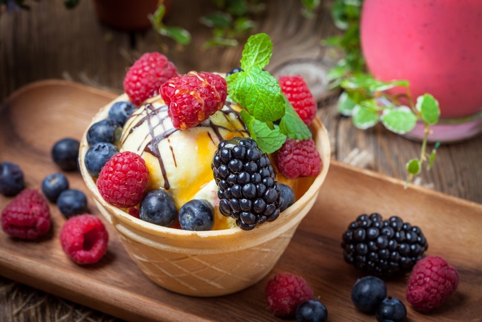 Ice cream with berries and chocolate drizzle