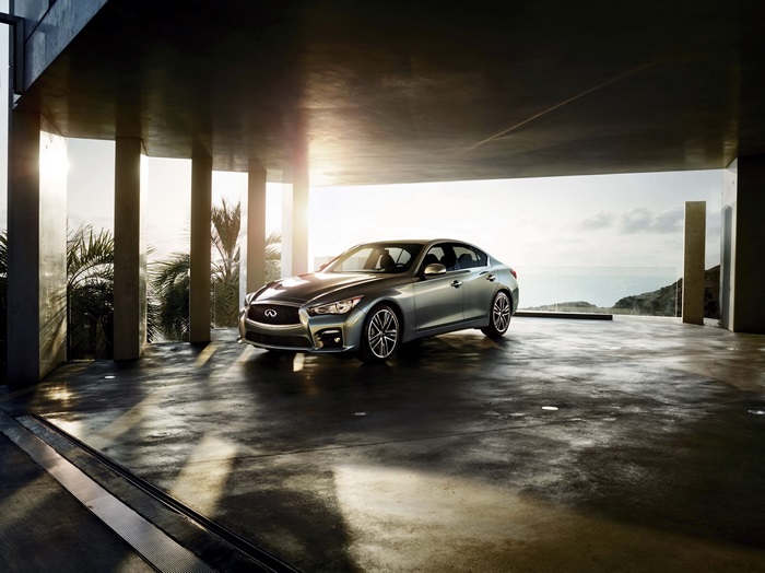 Infiniti Q50 in a modern garage overlooking the ocean