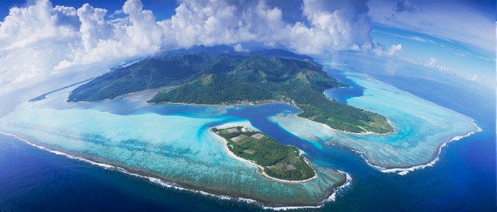 Aerial panorama of a tropical island with mountains and turquoise lagoon