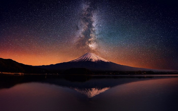 Mount Fuji under the Milky Way with lake reflection