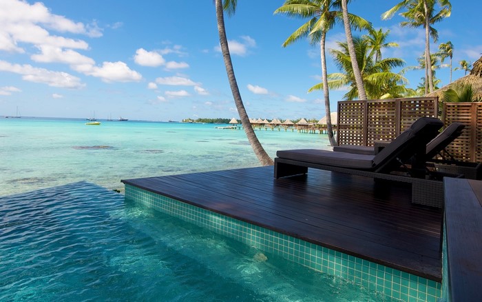Tropical resort with infinity pool and overwater bungalows