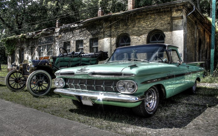 Chevrolet Bel Air and vintage car in front of building
