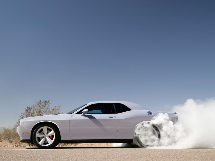 Dodge Challenger performing a burnout in the desert