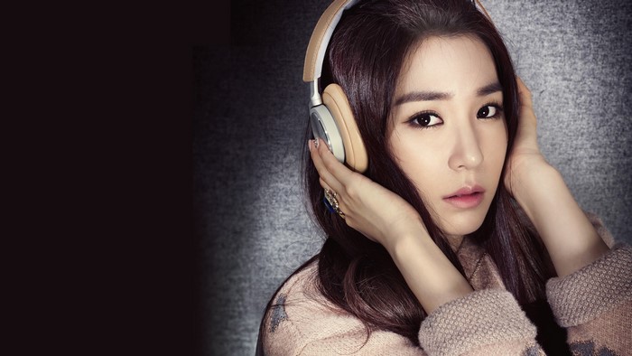 Woman wearing headphones and a sweater