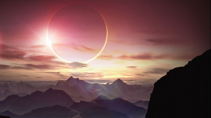 Solar eclipse over mountains