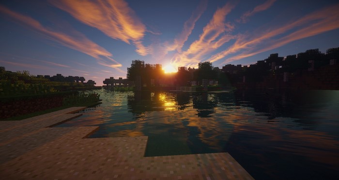 Minecraft sunset over a lake with shaders