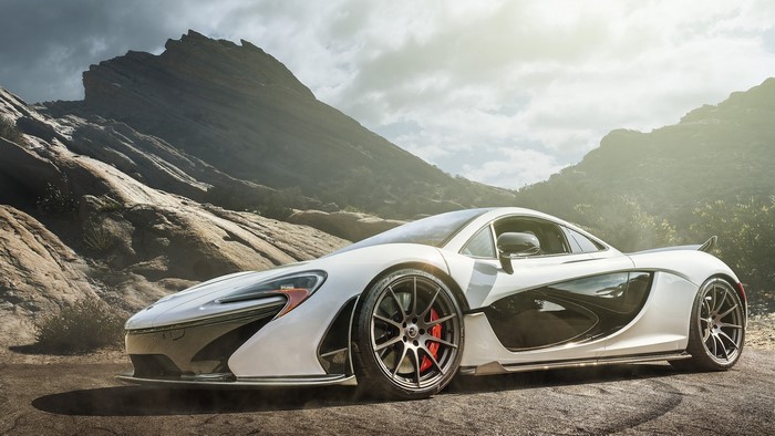 White McLaren P1 in a rocky, mountainous landscape