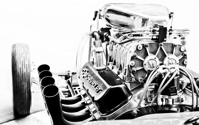Chevrolet engine with supercharger and exhaust pipes