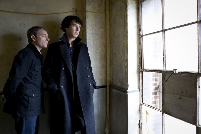 Sherlock Holmes and John Watson by a window