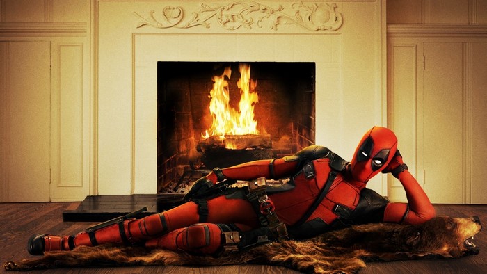 Deadpool posing by a fireplace