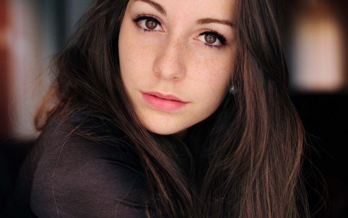 Brunette woman with freckles and brown eyes