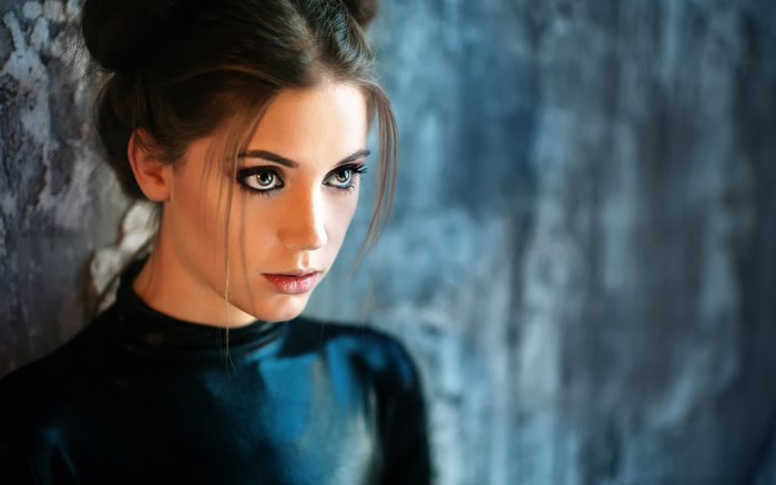 Woman with dark hair and dramatic makeup
