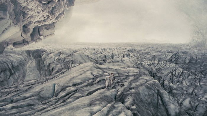 Two astronauts on a desolate icy planet