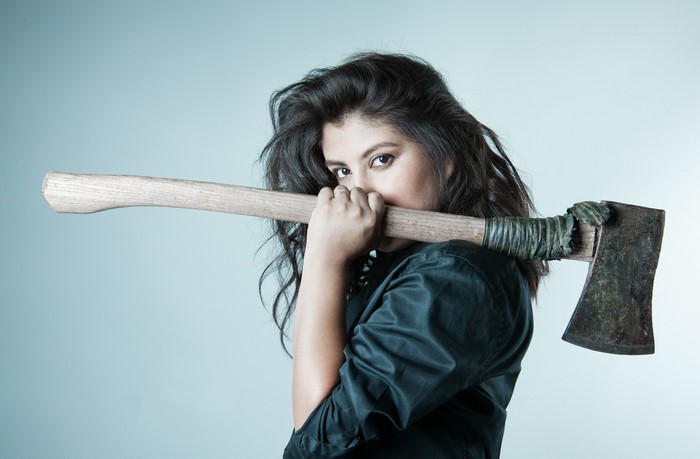 Woman holding an axe over her shoulder