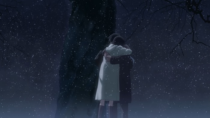 Two people hugging in the snow