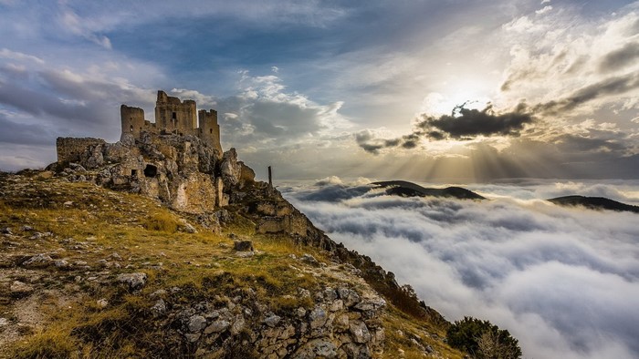 Rocca Calascio castle ruins above clouds in Italy